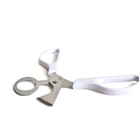 Photo - White raw quail egg scissors with stainless steel blades, used for splitting eggs open without mess. Shot in Montreal, Canada.